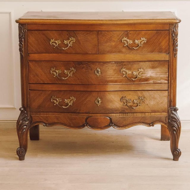 This commode was created around 1900 in the Louis XV style, incorporating the curved forms and rocaille ornamentation of...