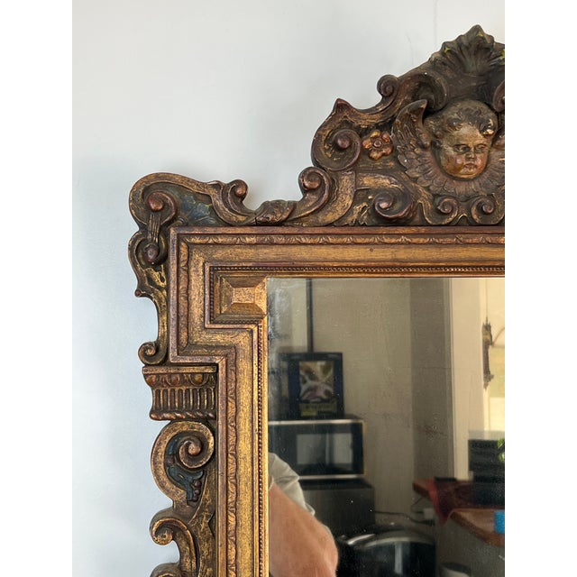 This stunning antique Italian wall mirror captures the opulence and artistry of the Regency style, featuring a deeply...