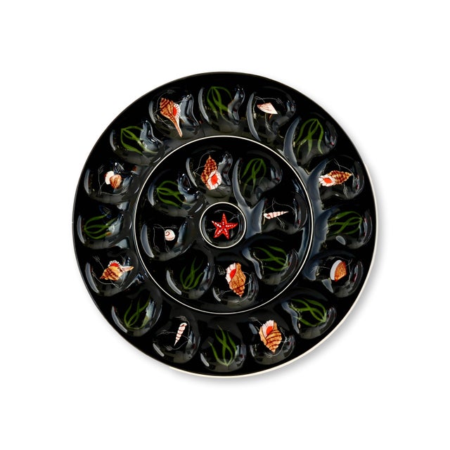A striking Henriot Quimper oyster service, featuring a large master serving plate and six 8.75" individual oyster plates,...