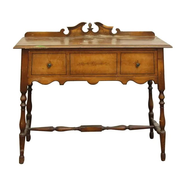 Traditional style wooden console table with two drawers and floral details at the top. The top surface is worn and needs...