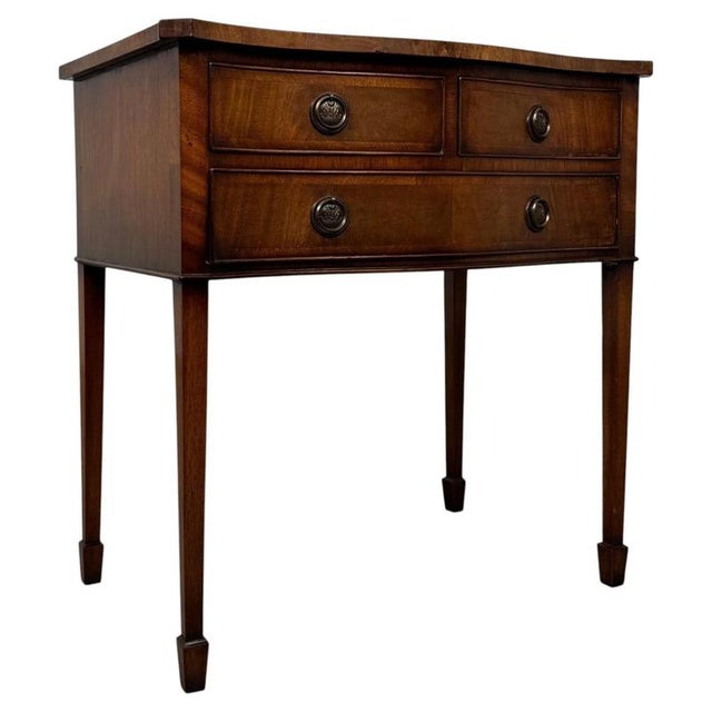 A particularly unusual and versatile early 20th-century English side table, finely crafted from mahogany and distinguished...