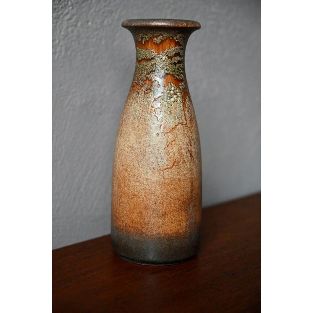 Mixture and superpositions of mineral colors and textures, and firing effects, the enamelling work of this vase is a...