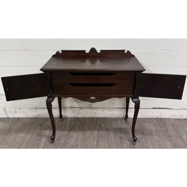 This is a beautiful vintage Georgian Revival mahogany tea server or hostess cabinet dating to the early twentieth century,...