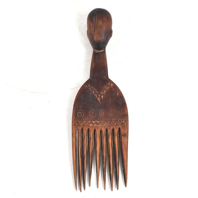 Beautiful wooden comb with hand-etched carvings is a wonderful addition for your collection! The red-wood stain gives it...