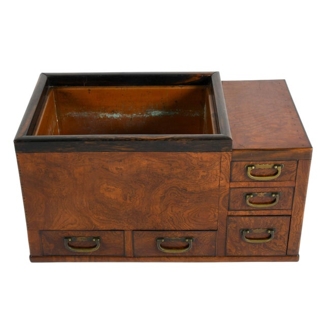 A striking example of traditional Japanese craftsmanship, this burlwood hibachi showcases richly figured grain with...