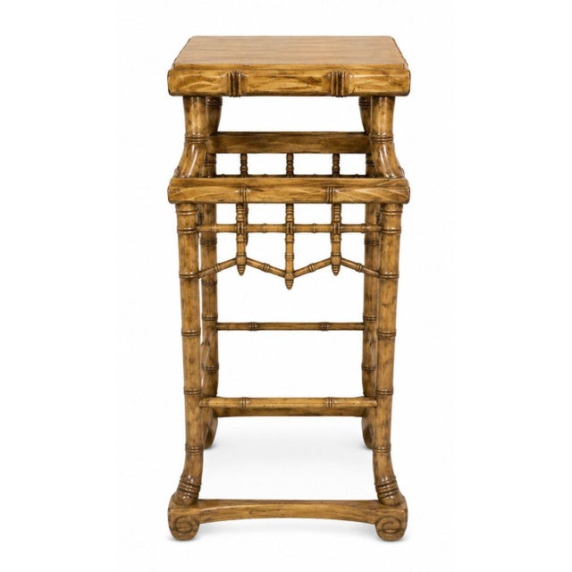 A charming pair of early 20th century Chinese hand-carved wood pedestals executed in an elegant faux bamboo form. Each...