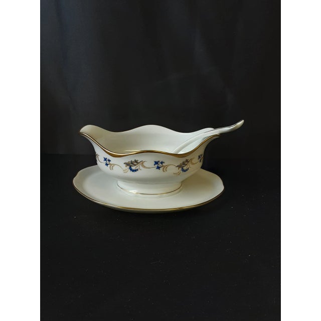 Vintage KPM porcelain gravy boat with spoon. Gold trim on edges, with blue and gold design. Spoon is 7" x 1.5" Gravy boat...