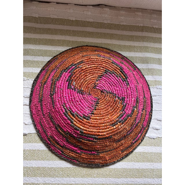 Indego African Geo Plateau Round Woven Basket. Hot pink and camel Size: 13.5"D x 2.5"H