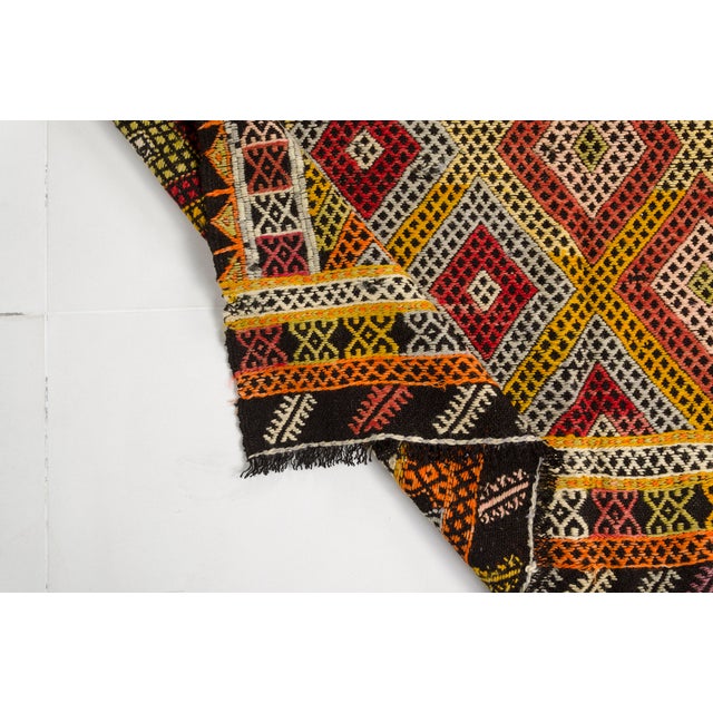 This is a vintage Turkish Oushak rug from the Mid 20th Century. The piece was hand-knotted.