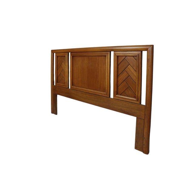 A queen size three panel headboard in maple by Dixie furniture, circa 1960. Two side panels carved to give a herringbone...