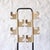 Two black lacquered steel axles support two sets of four beige plastic hooks for hanging clothes or hats. Being 360-degree...