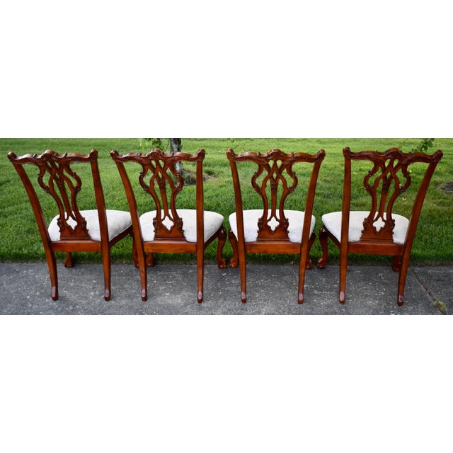 Vintage (1990's) Set of Four Dining Side Chairs have a Chippendale Style. The Wood is Cherry. Heavily Carved - Back has...