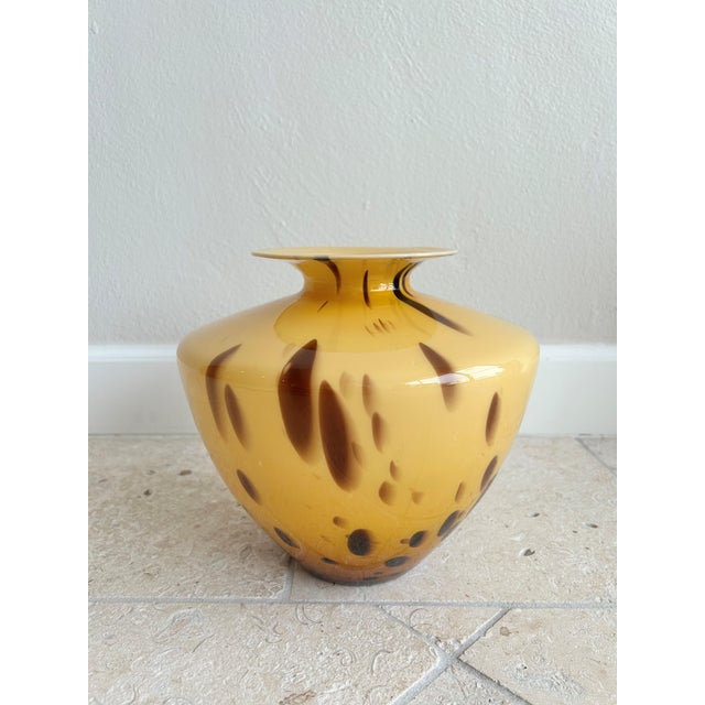 Hand blown in Italy circa 1970, this vintage glass vase features a dramatic tortoiseshell pattern with layered amber,...