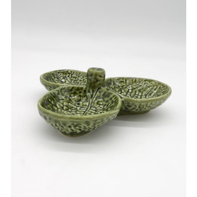 A charming Olfaire green cabbage leaf three-section condiment and relish dish, handcrafted in Portugal. Three individual...