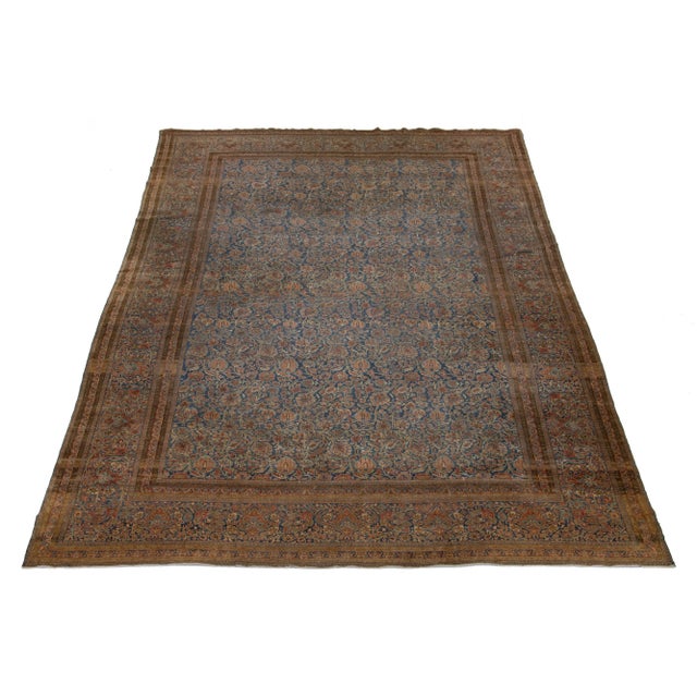 Discover the timeless beauty of an oversized, hand-knotted wool antique Kashan rug. Its intricate design features stunning...