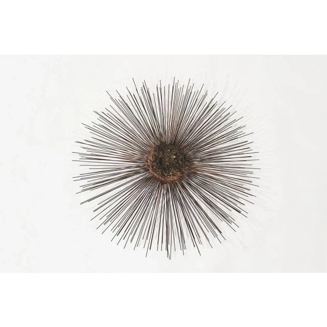 This 42" vintage Sunburst wall sculpture, crafted from mixed metal alloys, radiates industrial charm. Featuring textured...