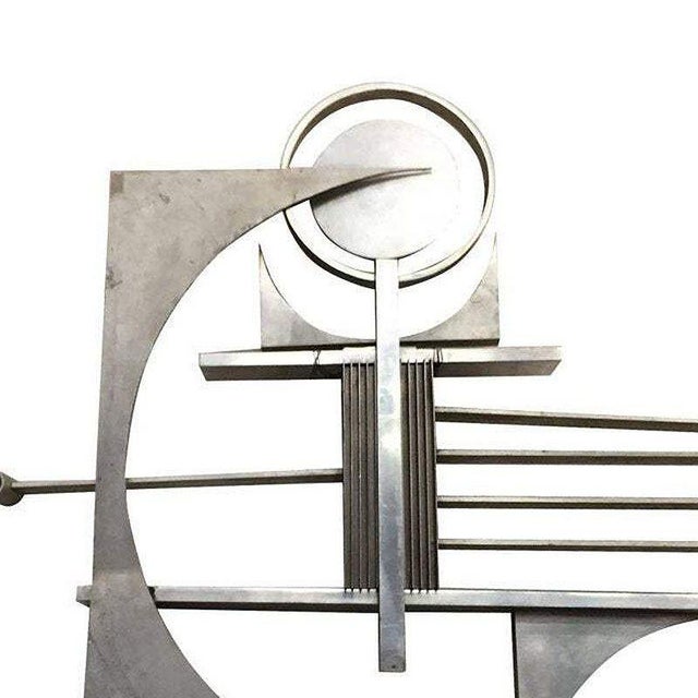 Brutalist free-form aluminum & steel art wall sculpture featuring brushed and polished piece cutting into corners, vents,...