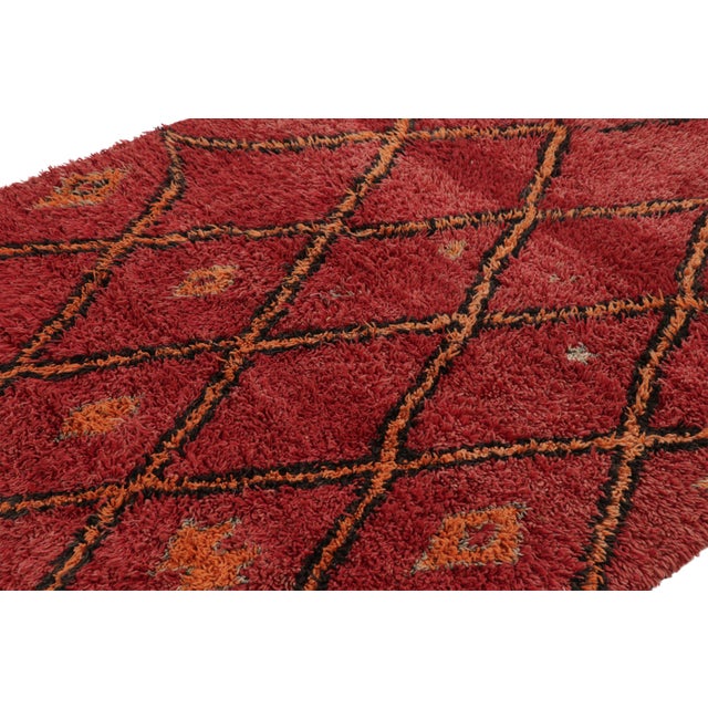 Hand-knotted in wool and originating from Morocco circa 1950-1960, this 5x7 vintage rug is a rare and among the most...