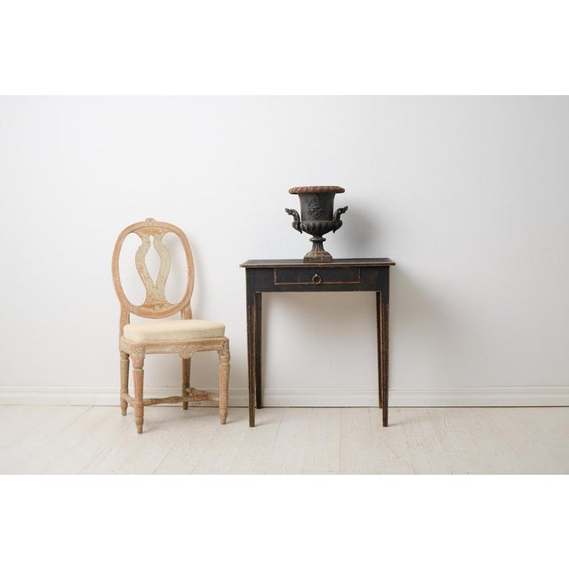 Swedish antique side table with a drawer in gustavian style. The table is small with a rectangular table top and a drawer...