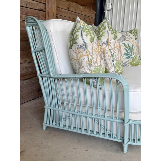 A remarkable mid-century rattan sofa that embodies the relaxed elegance of Old Florida design. Professionally restored and...
