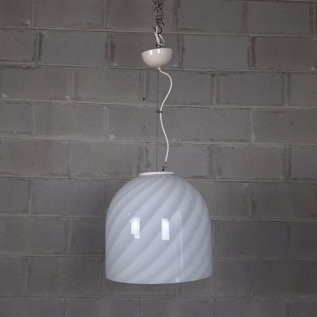 Stunning modern Italian pendant chandelier, dome-shaped lampshade, in white Murano glass with fantastic spiral design,...