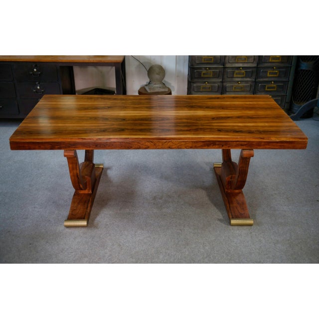 Elegant and generous, this Art Deco table showcases the beauty of wood with a superb rectangular top featuring deep, warm...