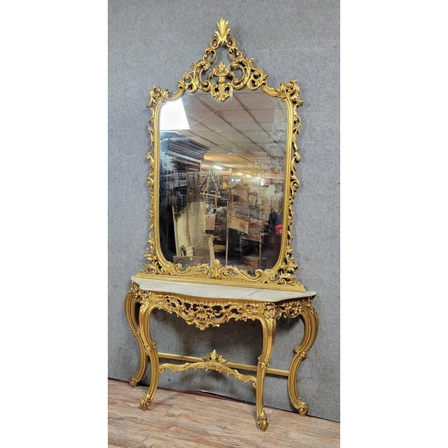 Large venetian console table and mirror in the louis xv baroque style, giltwood, 20th century with a flowing, serpentine...