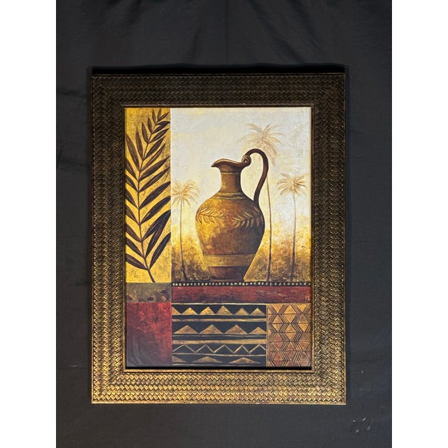 Elegant framed wall art featuring a central urn motif with palm tree accents, geometric patterns, and warm Mediterranean-...