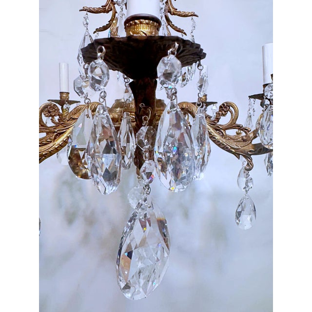 This is a decorative Spanish brass chandelier with 30% leaded almond cut drop crystal and octagon chain. The chandelier it...