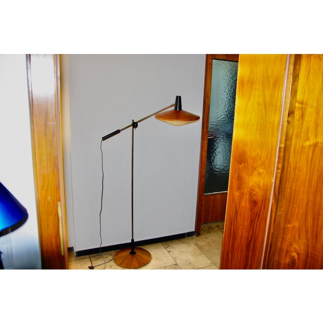 A very beautiful and rare 1960s architect's floor lamp by Georges Frydman, with an articulated teak-covered head and steel...