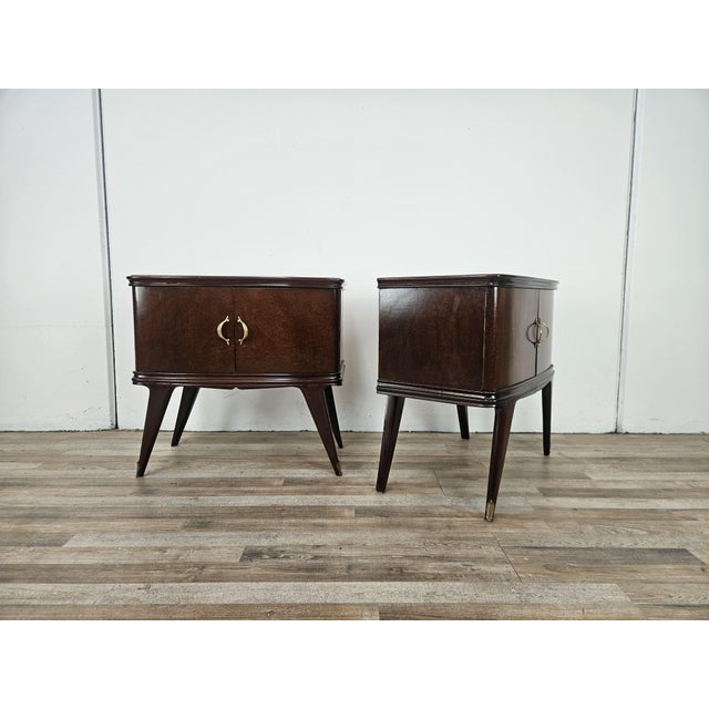 Fine and elegant pair of 1950s Art Deco mahogany crotchet nightstands with double doors and interior storage. The top is...