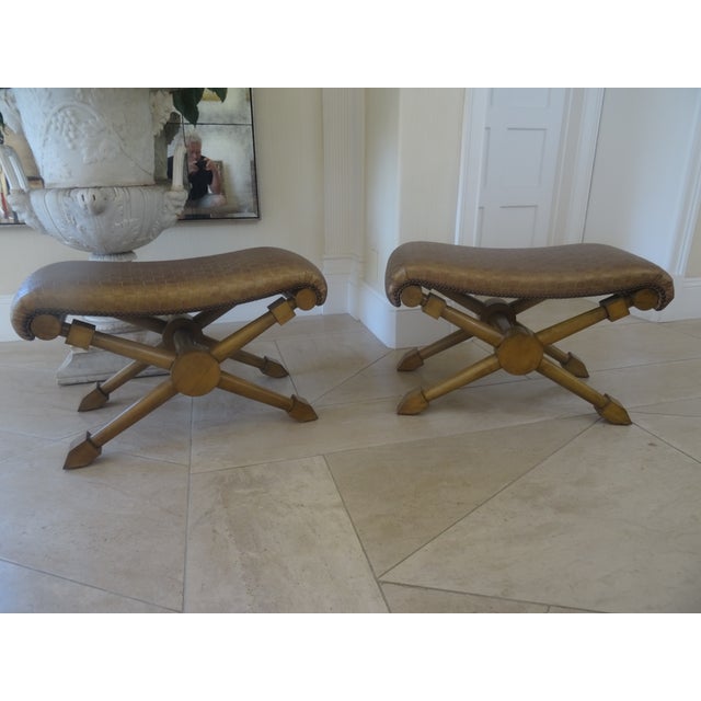 A fabulous pair of Ralph Lauren style benches with leather upholstery and nail head trim. A versitle pair with x form...