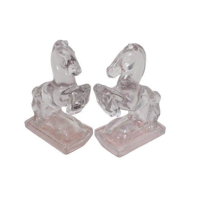 A pair of clear glass rearing horse bookends by L.E. Smith, circa 1940. Glass is cast with bold curved silhouettes and...