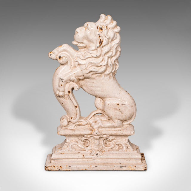 This is an antique heraldic lion doorstop. An English, painted cast iron door keeper, dating to the late Victorian period,...