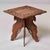 A richly carved Anglo-Indian occasional table featuring a square top with deeply carved foliate and floral border...