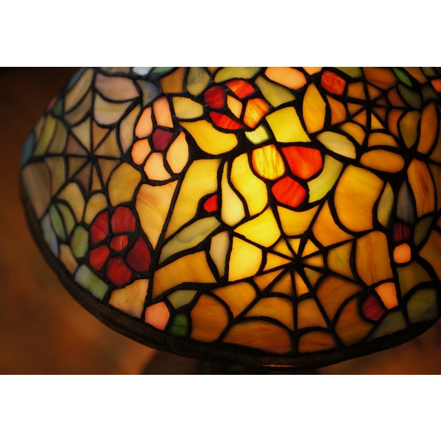 Available for sale is a beautiful collector level grade Tiffany-Style Stained Glass Lamp. Featuring "Cobwebs and Blossoms"...
