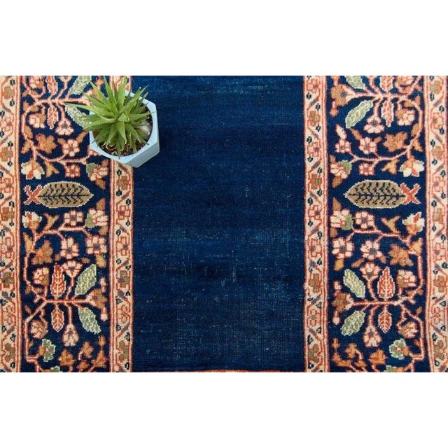 A gorgeous hand-knotted rug highlighting a striking empty blue color field and a decorative border design. Utilizing a...