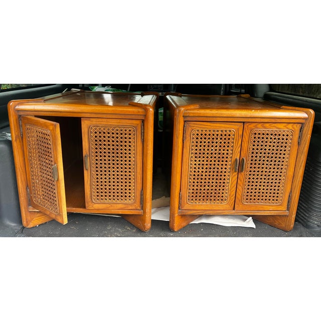Up for consideration is a beautiful vintage pair of wooden end tables with caned accents and deep storage. These would...