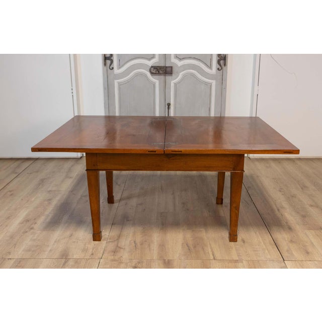 This exquisite Italian walnut folding table from the early 19th century embodies classic elegance with practical...