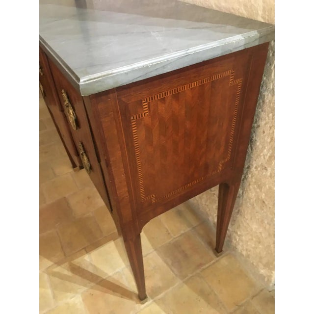 Elegant and perfectly sized 19th Century French Louis XVI style commode. This fine quality mahogany two-drawer commode has...