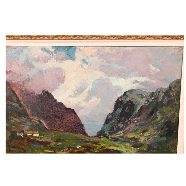 An oil painting capturing the rugged natural beauty of the Irish countryside in an ornate, gilt frame. The scenic...