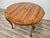 An elegant round table in solid walnut, crafted in the Baroque style and characterized by rich, harmonious lines that...