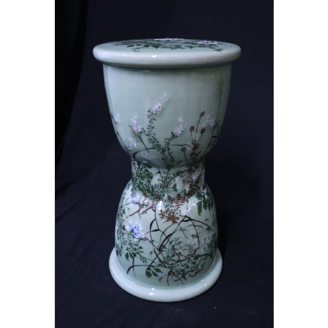 Beautiful and uniquely shaped vintage Japanese celadon garden stool. Light blue background decorated with tree branches...