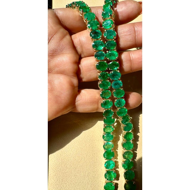 110 Ct Oval Natural very fine color oval Emerald set in 14 Karat Yellow Gold is a stunning piece. This necklace showcases...