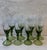 Set of 8 handblown green wine glasses with beautiful detail on the step and a bell foot. Perfect for your holiday table.