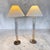 An elegant pair of signed Ralph Lauren Home table lamps featuring substantial tubular glass columns anchored by solid...