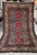 Caucasian Shirvan design hand-knotted rug featuring four bold eight-pointed Lesghi star medallions in crimson with crisp...