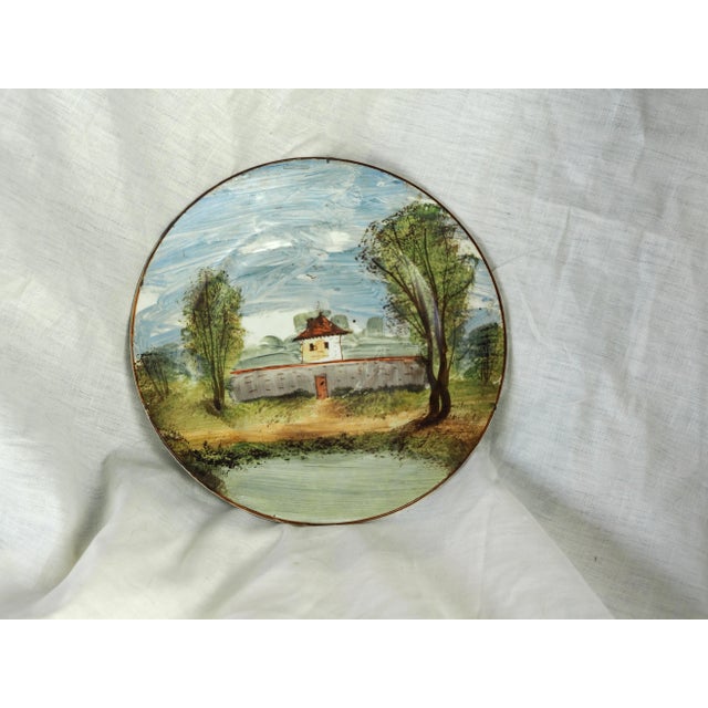 Pair of plates with rural landscape: mill surrounded by trees and overflown by birds in front of its pond, fortified farm...