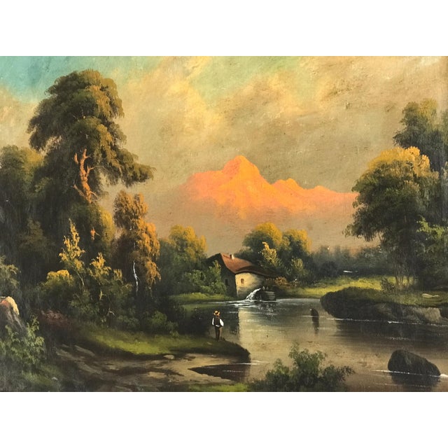 Offered here an atmospheric antique european oil painting, unsigned, depicting a tranquil river landscape with a lone...