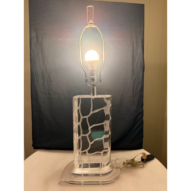 Authentic postmodern table lamp by Van Teal, featuring a sculptural stacked etched lucite (acrylic) base with organic...
